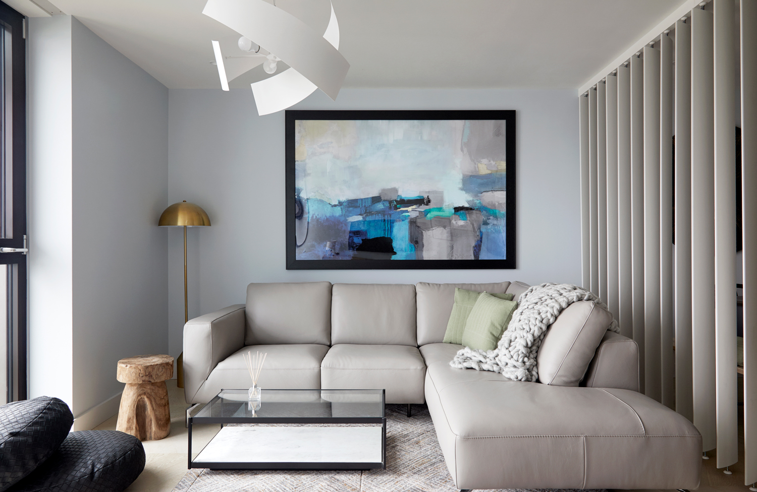 A large piece of art designed to balance the minimalist look to the rest of the room. The blues within this piece of art give depth to an otherwise flat colour scheme.