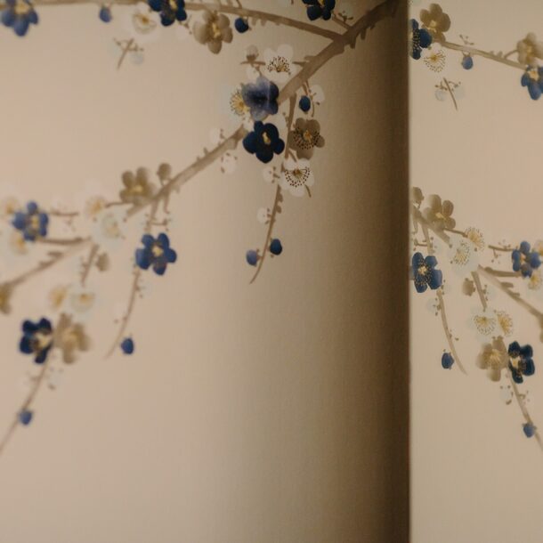 Paper cut-out floral branches on a wall