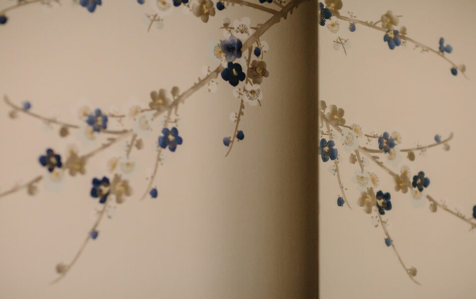 Paper cut-out floral branches on a wall